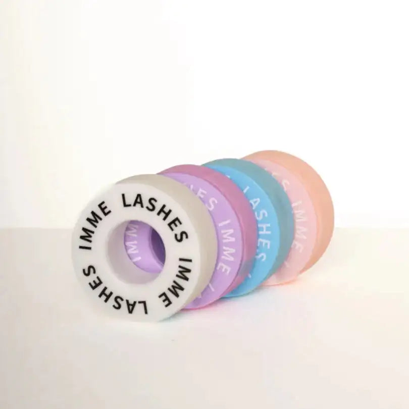 Pastel-colored imme lashes adhesive tape rolls in soft lavender, mint green, and peach hues with a matte finish.