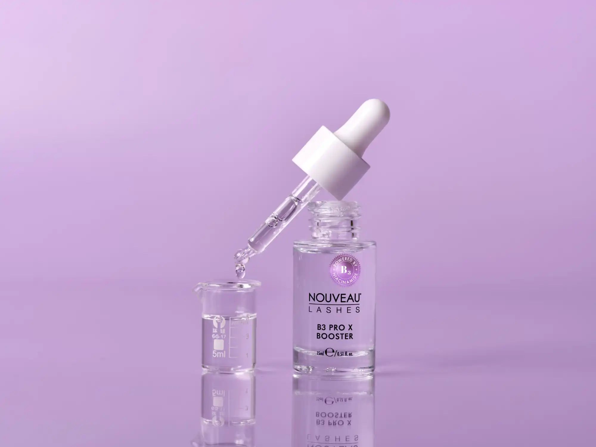 Nouveau lashes pro 10 booster clear glass dropper bottle with white cap.